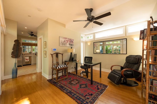 office area featuring a ceiling fan, wood finished floors, a wealth of natural light, and baseboards