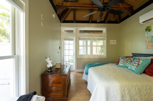 bedroom with beam ceiling, baseboards, wood finished floors, and a wall mounted AC