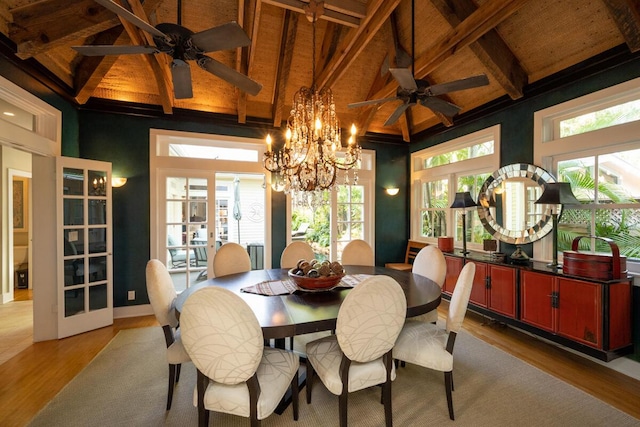 dining room with ceiling fan, french doors, lofted ceiling with beams, and wood finished floors