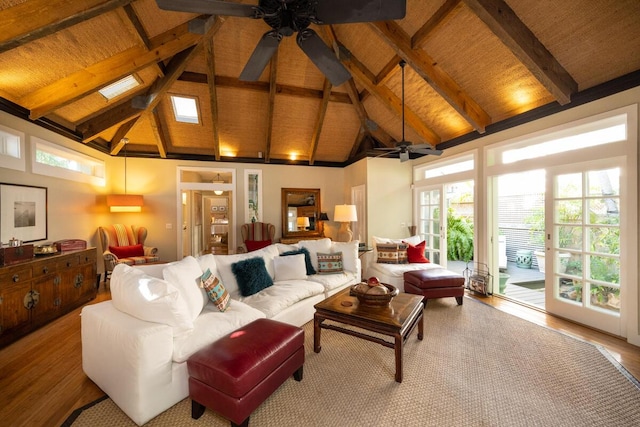 living area with high vaulted ceiling, a ceiling fan, wood finished floors, and beamed ceiling