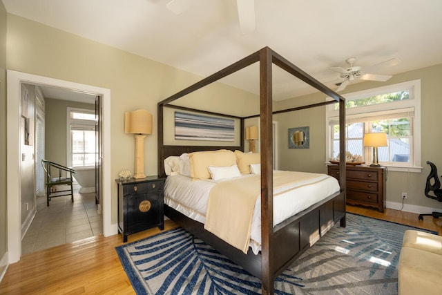 bedroom with ceiling fan, baseboards, and wood finished floors