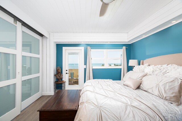 bedroom featuring wood ceiling, hardwood / wood-style flooring, and french doors