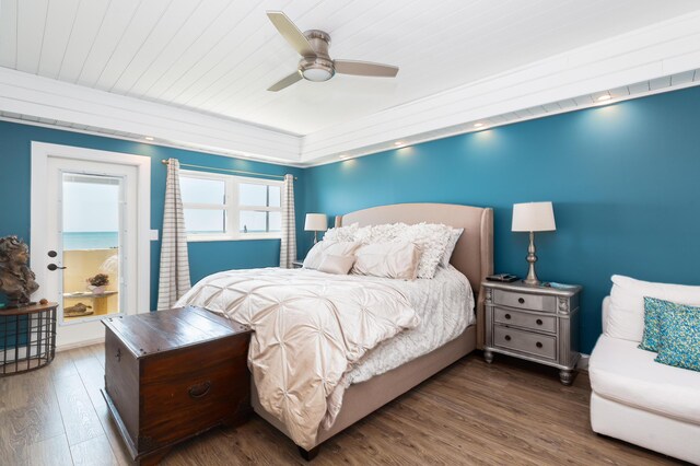 bedroom featuring dark hardwood / wood-style floors, wood ceiling, and ceiling fan