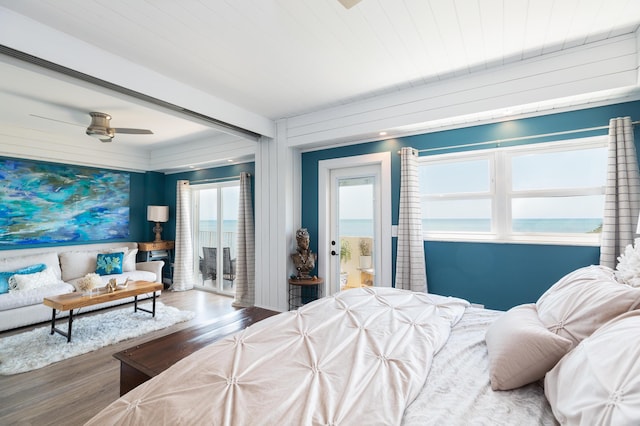 bedroom featuring wood-type flooring and a water view