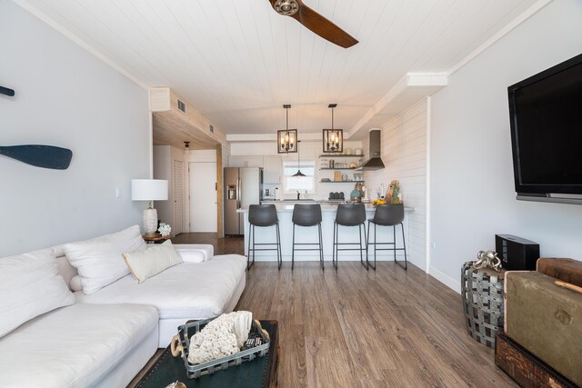 living room featuring hardwood / wood-style flooring, ceiling fan, and wooden ceiling