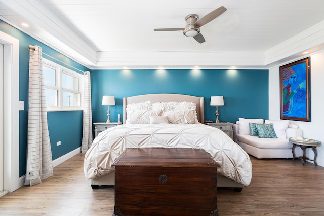 bedroom featuring hardwood / wood-style flooring, crown molding, and ceiling fan