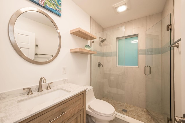 full bath with toilet, a shower stall, and vanity