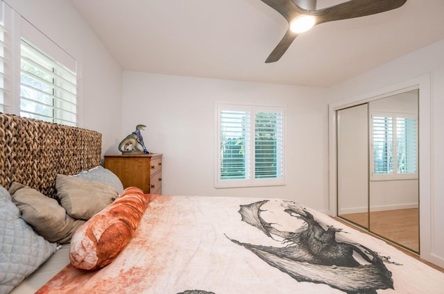 bedroom with a closet, ceiling fan, and wood finished floors