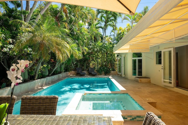 view of swimming pool featuring a patio and a pool with connected hot tub