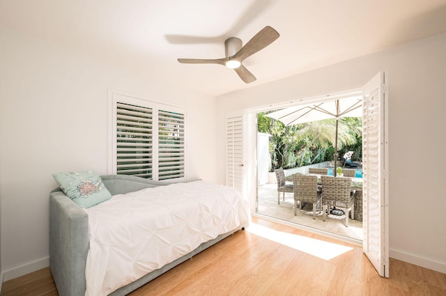 bedroom with access to outside, baseboards, ceiling fan, and wood finished floors