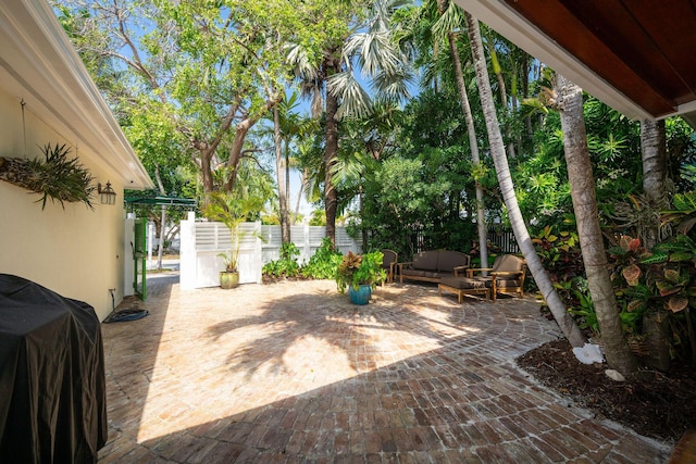 view of patio / terrace with outdoor lounge area, fence, and grilling area