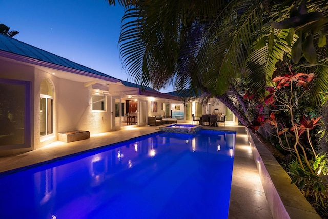 view of pool featuring a pool with connected hot tub and a patio