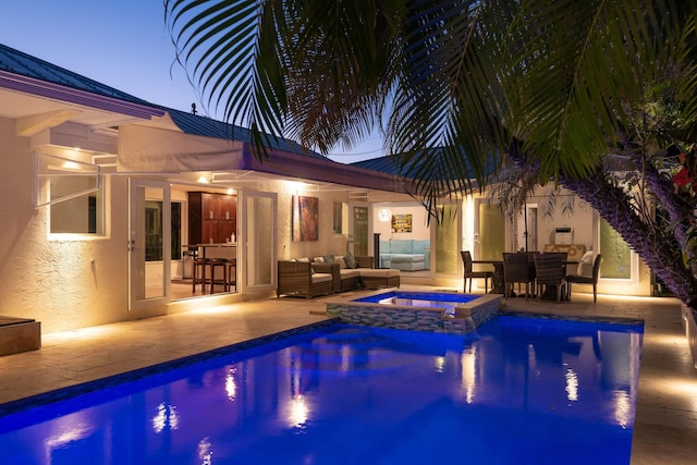 view of pool with a pool with connected hot tub, outdoor lounge area, and a patio