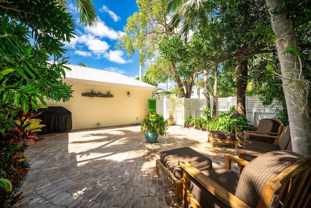 view of patio / terrace with fence and a grill