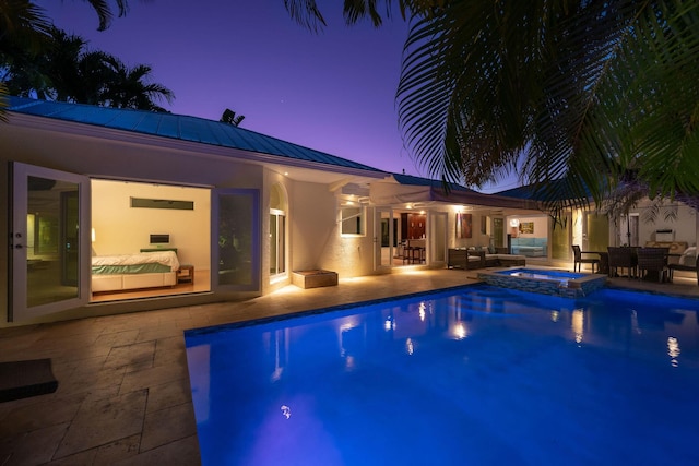 view of pool featuring a patio area and a pool with connected hot tub