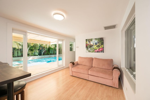 living area featuring wood finished floors and visible vents