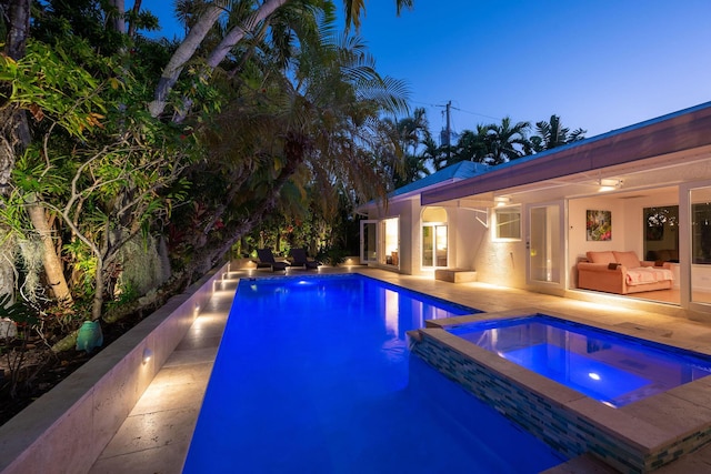 pool featuring a patio and an in ground hot tub