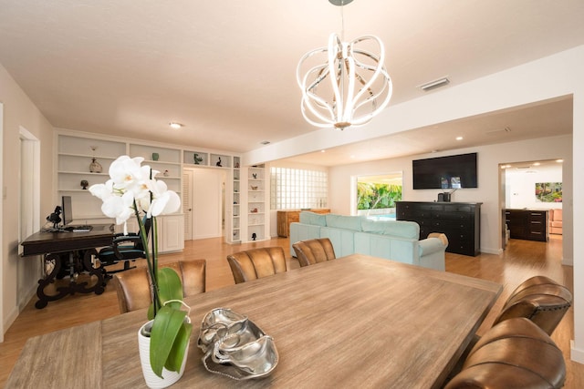 dining area with recessed lighting, visible vents, light wood-style floors, a chandelier, and baseboards