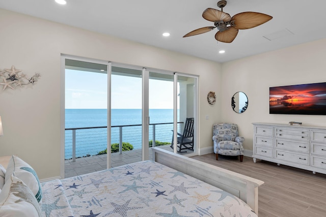 bedroom with a water view, ceiling fan, light hardwood / wood-style flooring, and access to outside