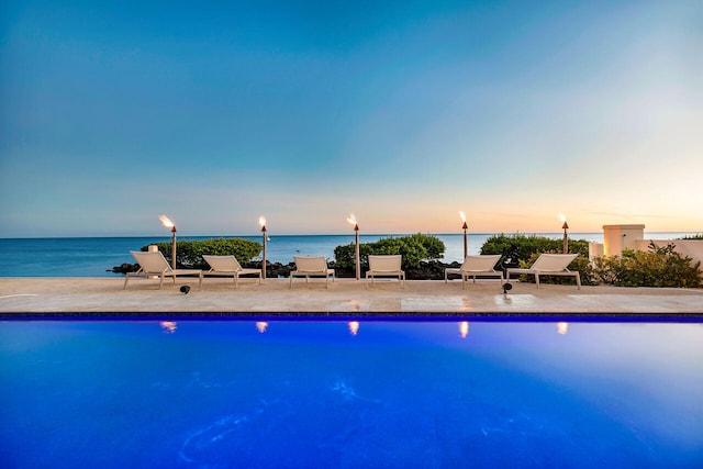 pool at dusk with a water view