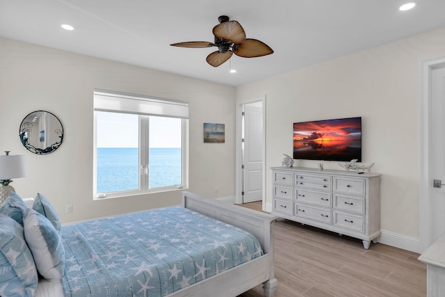 bedroom featuring ceiling fan and light hardwood / wood-style flooring