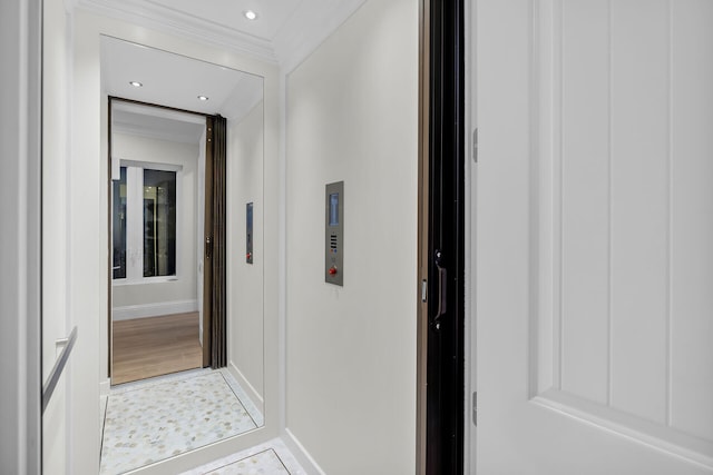 corridor featuring crown molding and elevator