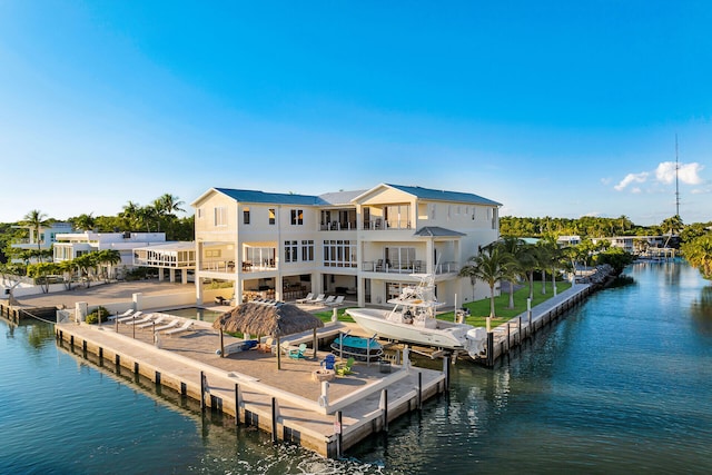 dock area with a water view and a balcony