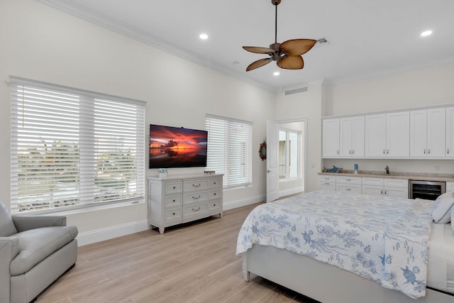 bedroom with sink, wine cooler, ceiling fan, light hardwood / wood-style floors, and crown molding