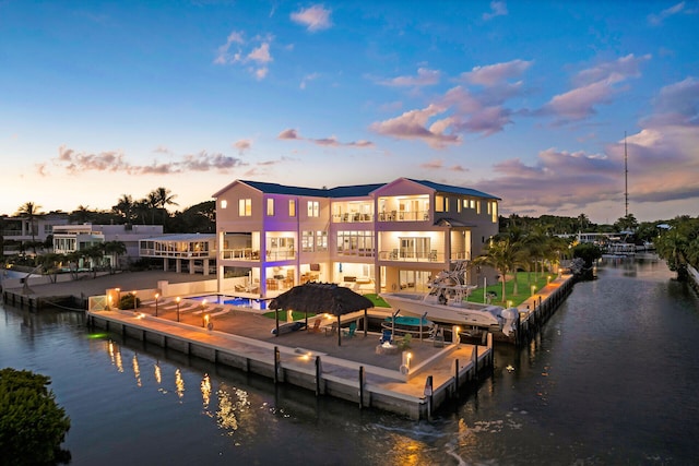 dock area with a balcony and a water view