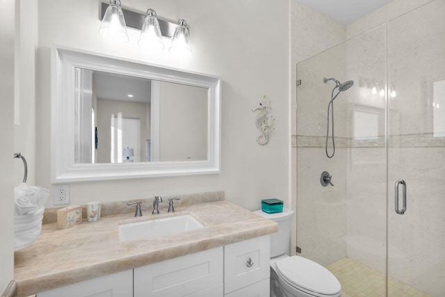 bathroom featuring vanity, toilet, and an enclosed shower