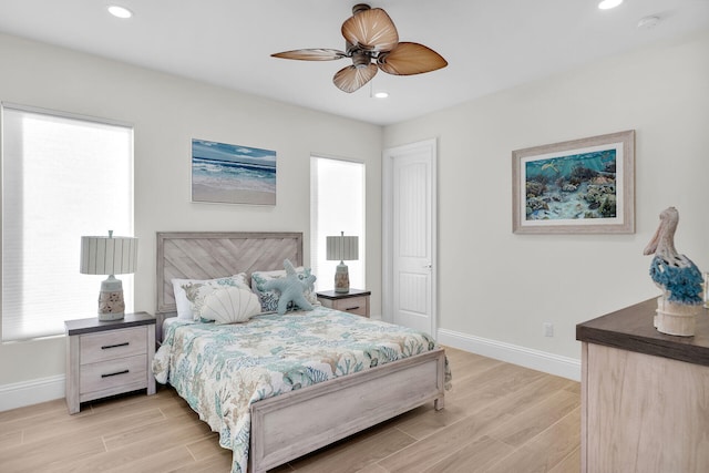 bedroom with ceiling fan and light hardwood / wood-style floors