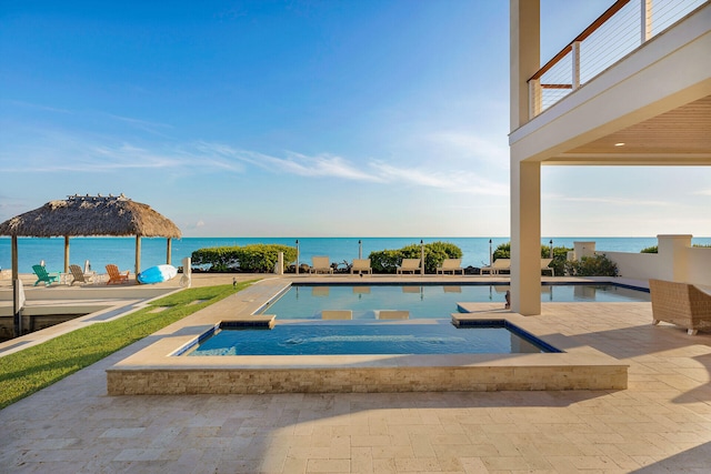 view of pool featuring a gazebo, a water view, a jacuzzi, and a patio area