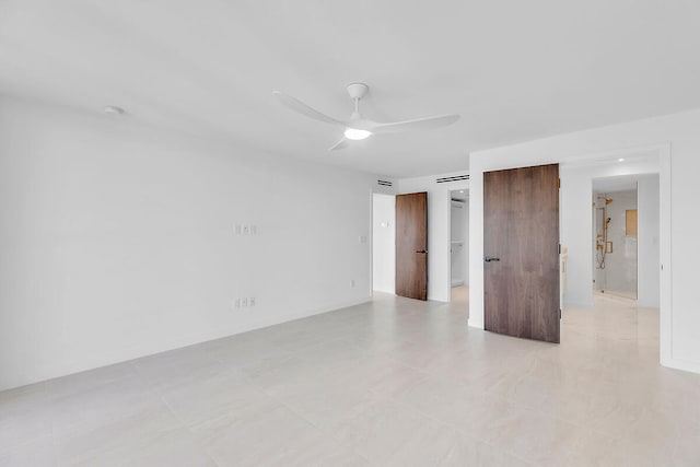 spare room featuring baseboards and a ceiling fan
