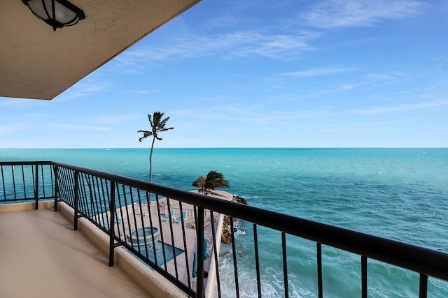 balcony featuring a water view