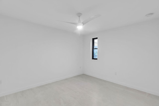 unfurnished room with baseboards and a ceiling fan
