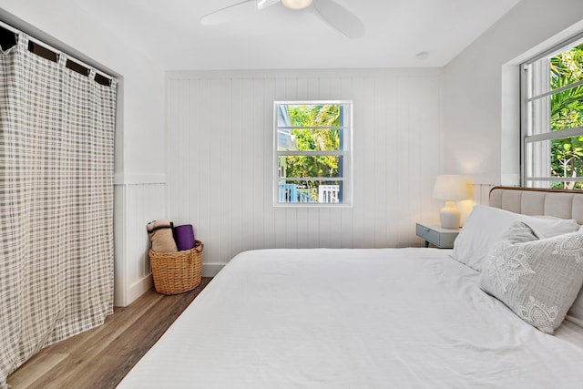 bedroom with ceiling fan and hardwood / wood-style floors