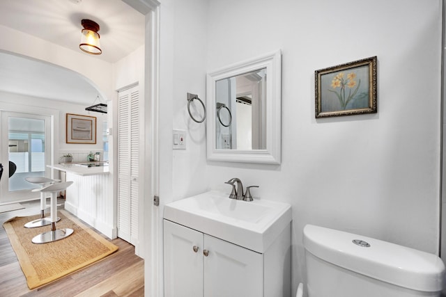 bathroom featuring hardwood / wood-style flooring, vanity, and toilet