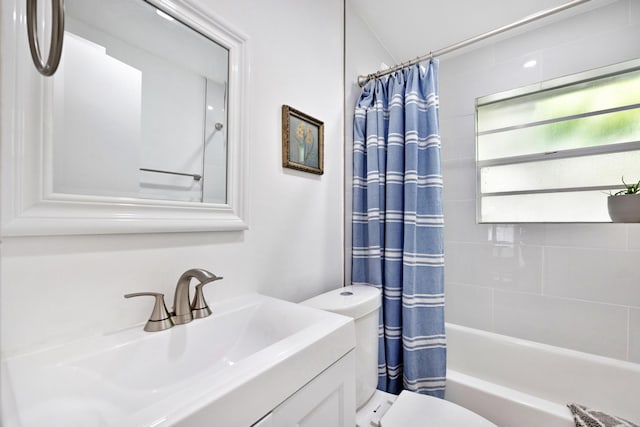 full bathroom with vanity, toilet, and shower / tub combo