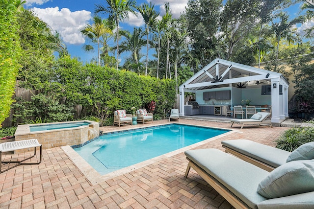 view of swimming pool with an outdoor kitchen, area for grilling, an in ground hot tub, an outdoor hangout area, and a patio area