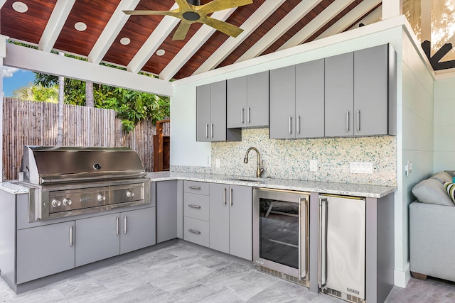 kitchen featuring sink, high quality fridge, wine cooler, and gray cabinetry