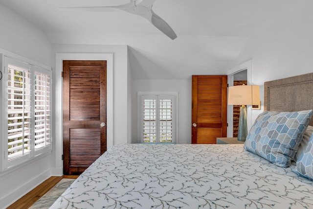 bedroom featuring hardwood / wood-style flooring, ceiling fan, and lofted ceiling