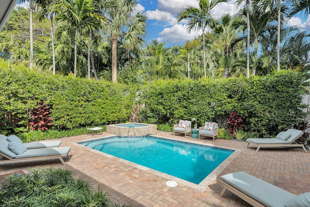 view of swimming pool featuring an in ground hot tub and a patio area