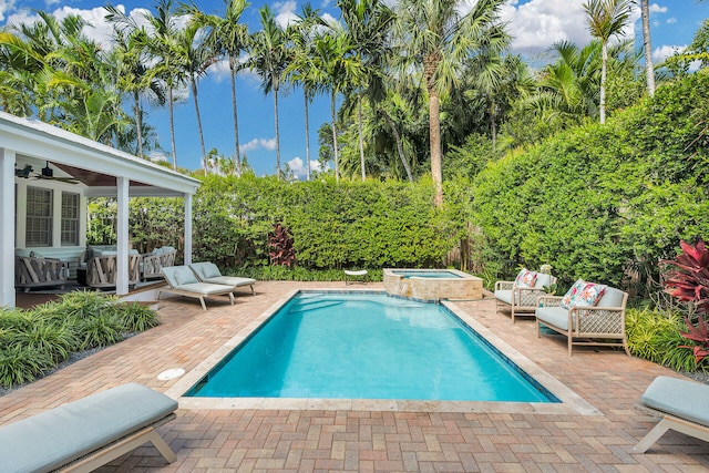 view of swimming pool featuring an in ground hot tub, outdoor lounge area, ceiling fan, and a patio area