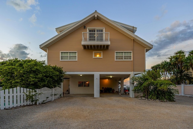 rear view of house with a carport and a balcony