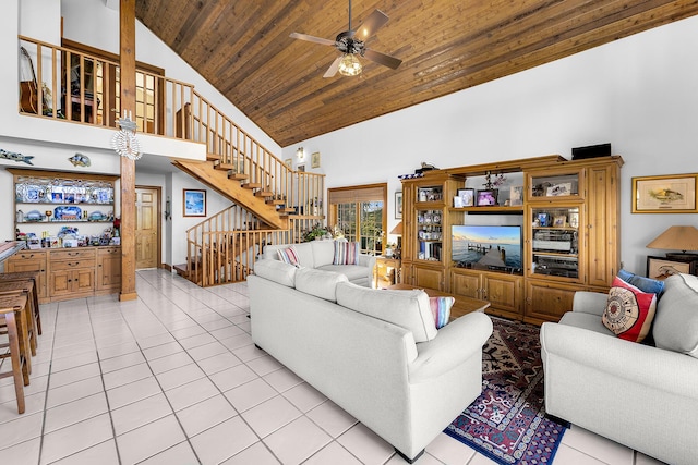 tiled living room with wood ceiling, ceiling fan, and high vaulted ceiling