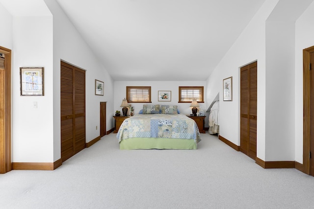 bedroom with vaulted ceiling and light carpet