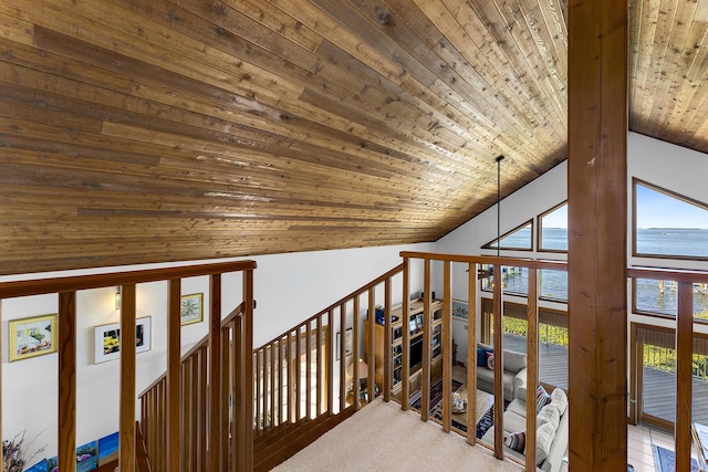 corridor with a water view, carpet flooring, wooden ceiling, and high vaulted ceiling