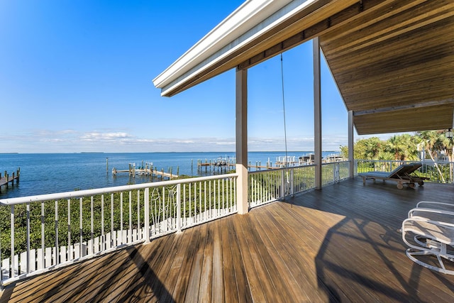 wooden terrace featuring a water view