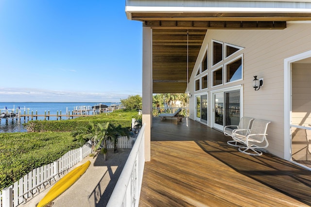 wooden terrace featuring a water view