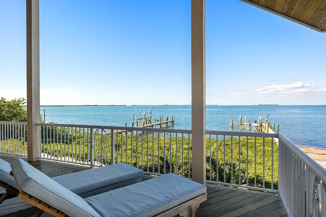 wooden terrace featuring a water view